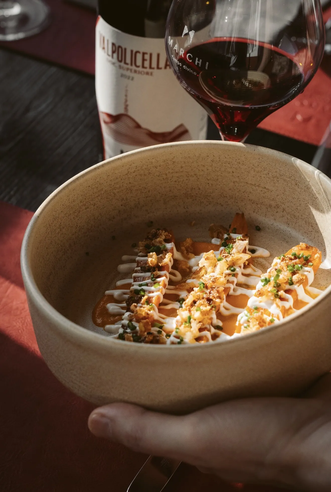 Finished dish held in a restaurant setting